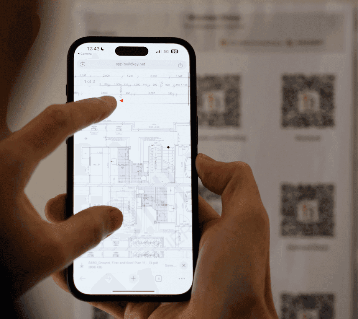 Scanning a Buildkey QR poster to open the latest plans on a phone